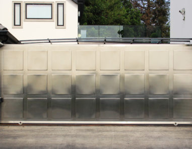 single slide auto gate in contemporary stainless steel with medallions