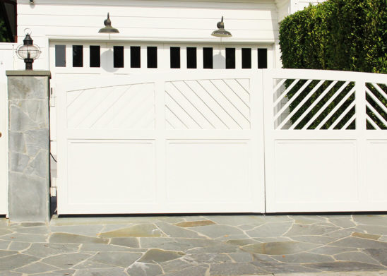 custom contemporary wood bifold auto gate and hinged pedestrian gate