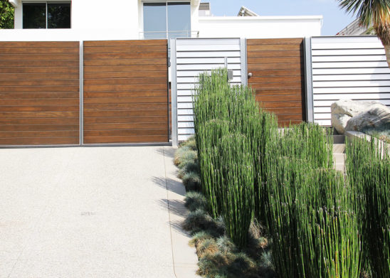 horizontal wood and aluminum bifold auto gate and hinged pedestrian gate