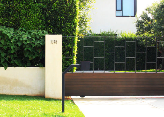 contemporary wood and steel auto sliding gate and hinged pedestrian gate